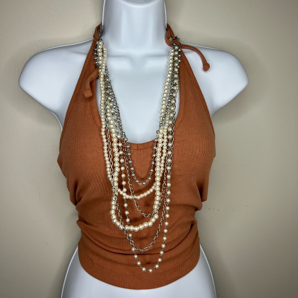Multi strand metal and pearl drape necklace. Adjustable clasp for sizing.